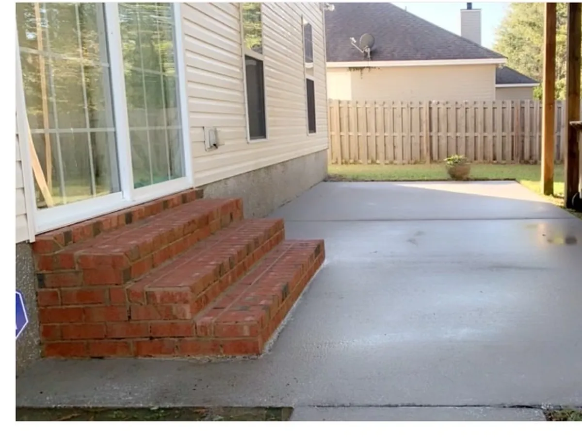Clean, restored concrete driveway after pressure washing