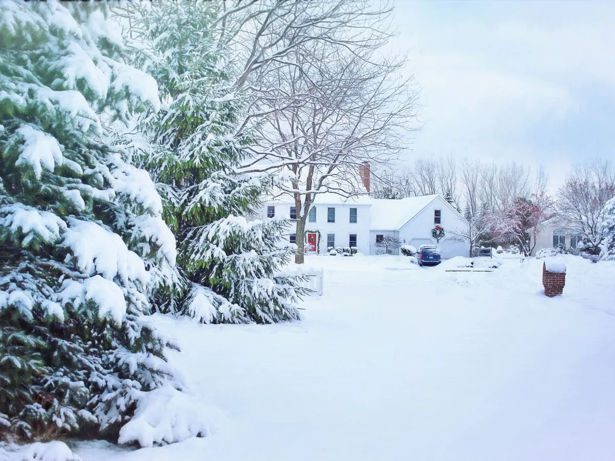 Snow-covered driveway and walkway before clearing